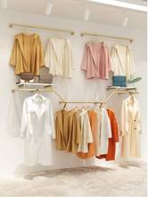 Estante de exhibición de tienda de ropa para mujer, colgador de ropa dorado para colgar en la pared 2024 - compra barato