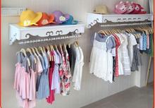 High-end women's clothing shelves. White wall-mounted hangers. Clothing store hangers.005 2024 - buy cheap