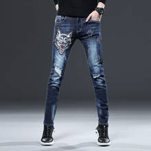 Atacado 2021 denim cabeça de lobo bordado personalidade jeans masculina na moda marca high-end estiramento lápis calças 2024 - compre barato